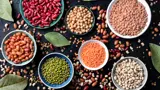 A view from above of dried beans and lentils in bowls loading=